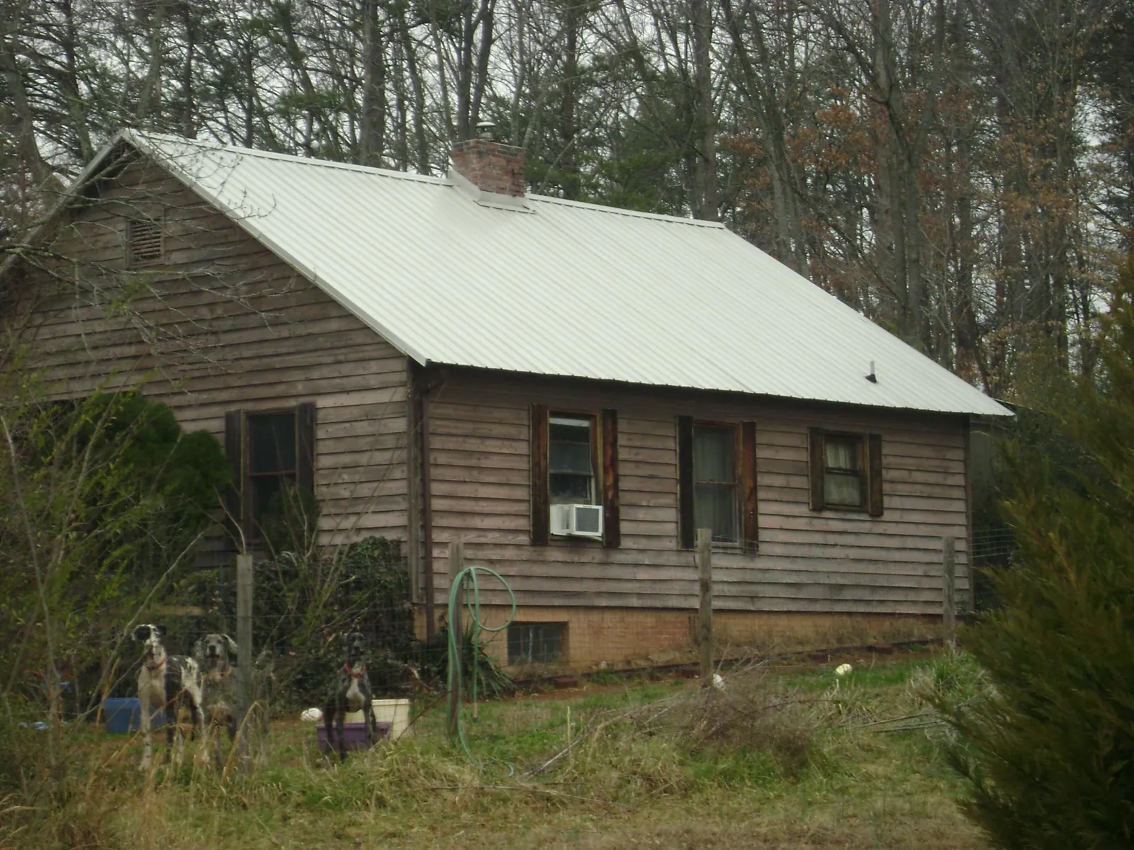 White metal roof on an old wood sided farmhouse, from a Metal Roof Installation job in Cross Anchor